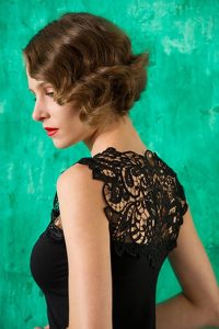 Model wearing a black top with beautiful upper back lace.