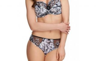 Model wearing brown and white bra and panties set with floral print