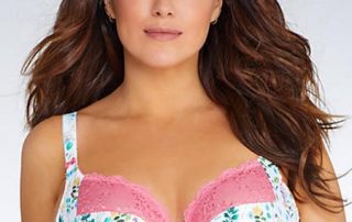 Model wearing a colorful floral print bra with pink lace